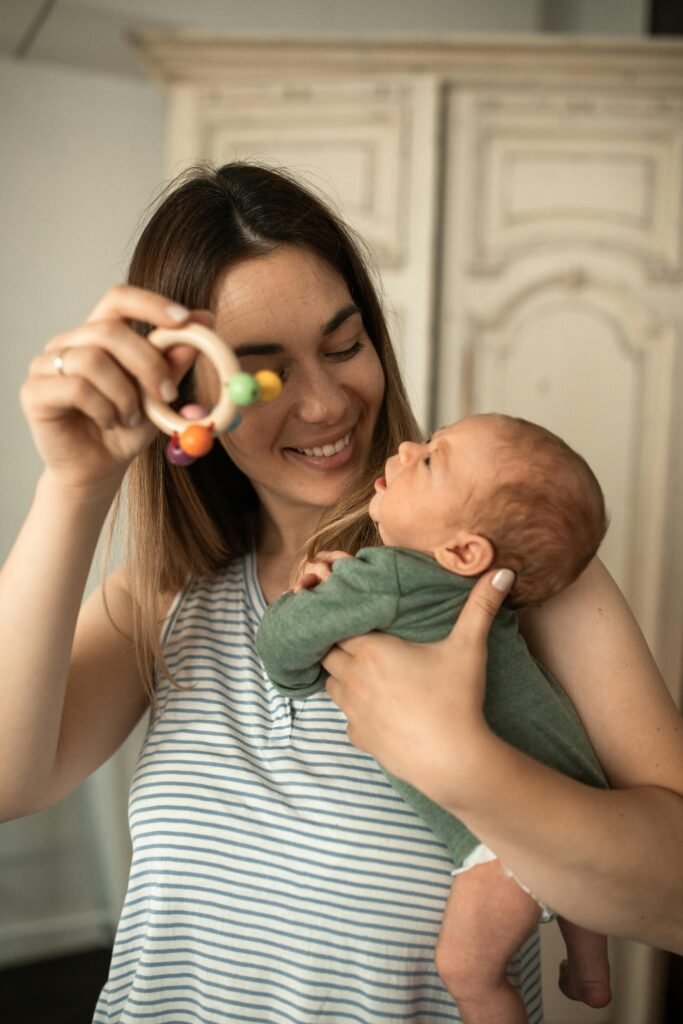 Mother playing with her newborn